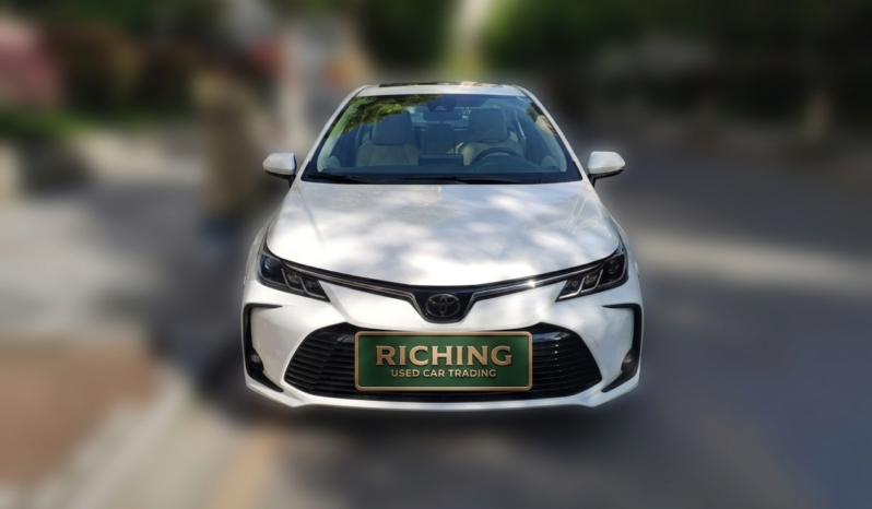 Front view of a white 2021 Toyota Corolla Elite Edition sedan with TNGA 1.5L engine.