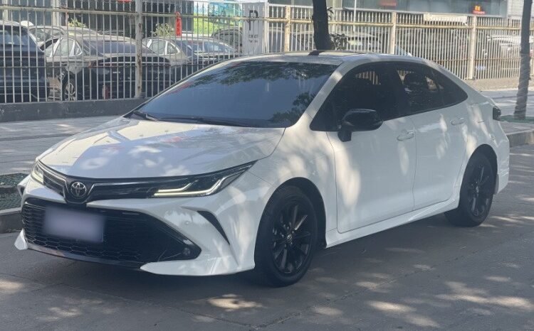 White 2021 Toyota Corolla GR SPORT Sedan front three-quarter view with black mesh grille.
