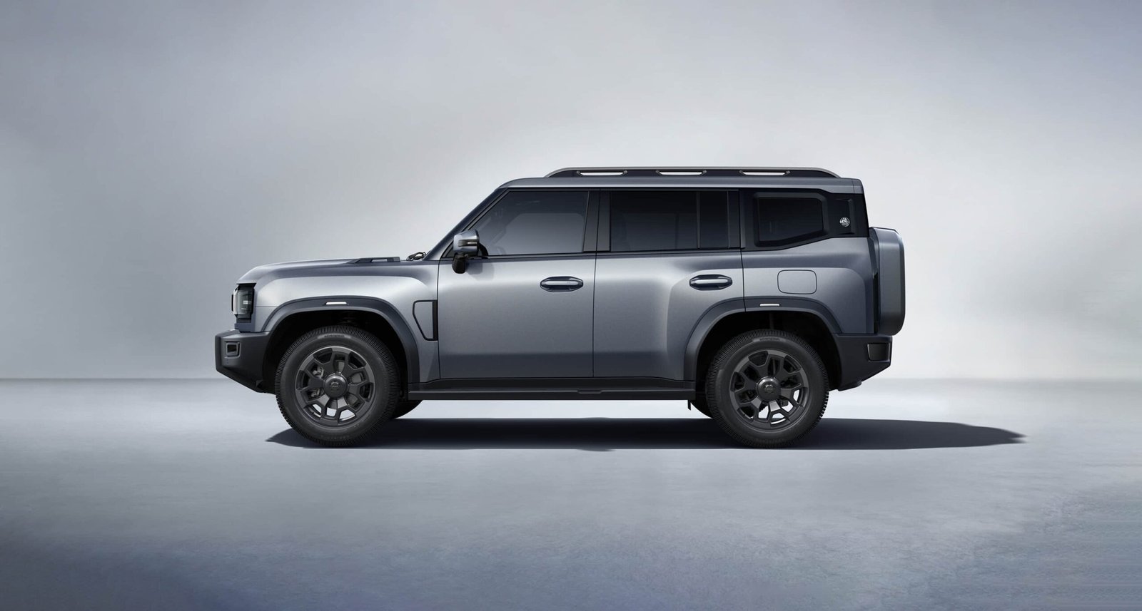 Jetour Traveler SUV side profile showing rugged boxy design, roof rails, dark wheels, and off-road styling.
