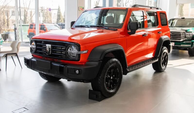 Front three-quarter view of Beijing 212 T01 orange off-road SUV showing round headlights, black grille, rugged bumper, black wheels, roof rails and showroom display