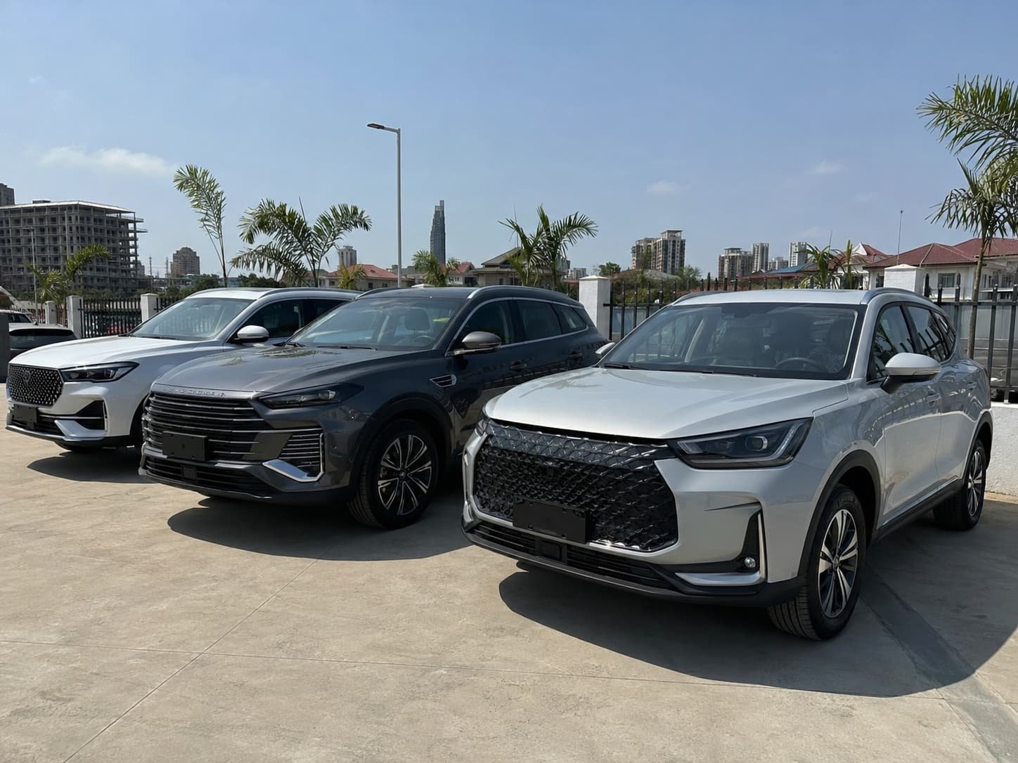 Changan CS55 and Jetour X70 compact SUVs lined up at an Accra Ghana dealer lot after import from China via Tema Port