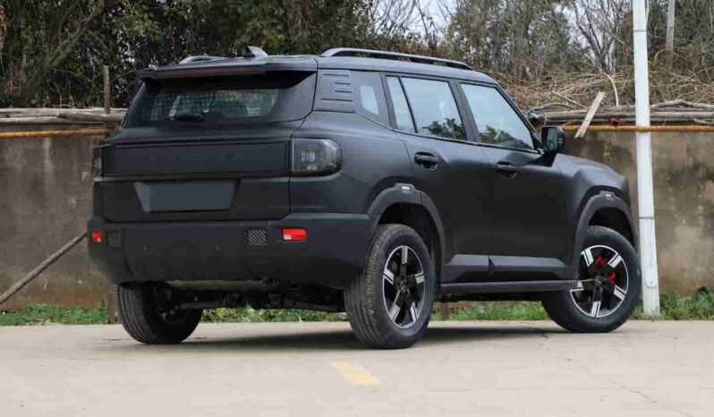 Rear three-quarter view of Jetour Shanhai T1 SUV showing the boxy off-road body design, rear tailgate, roof rails, alloy wheels and dark grey exterior