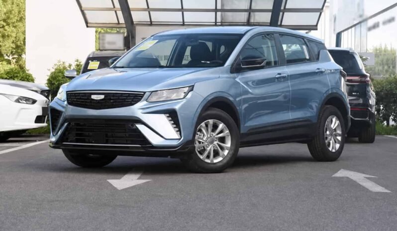 Front three-quarter view of Geely Coolray light blue SUV showing front grille, headlights, alloy wheels, side profile and outdoor parking display