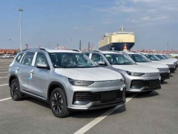 Brand new Chinese SUVs with factory protective film on body panels at a Guangzhou vehicle export yard ready for overseas shipment