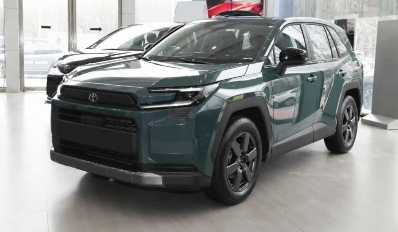 Front three-quarter view of Toyota RAV4 2026 AWD SUV in green with black roof, showing LED headlights, front grille, alloy wheels and showroom display